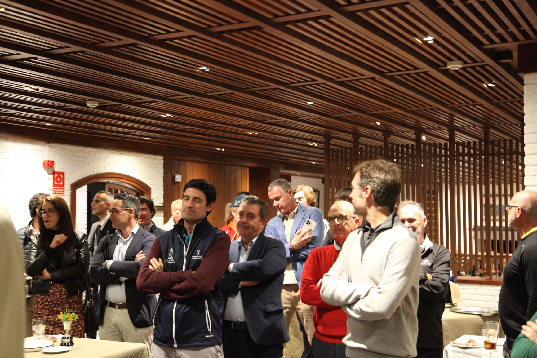 Ordzhonikidze (standing in the middle holding the phone) at an event at the local golf club in Sotogrande